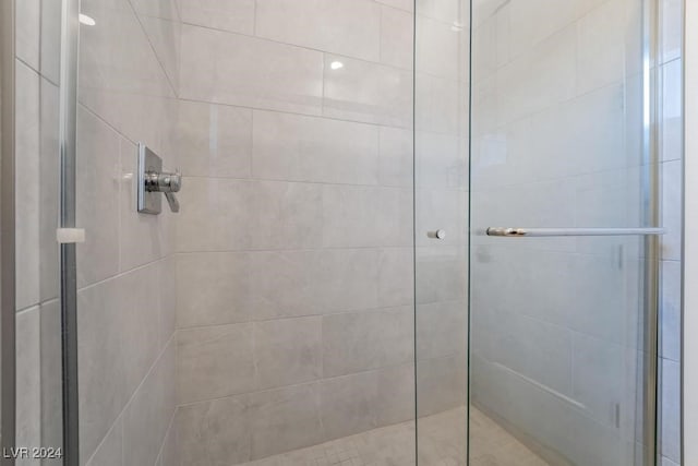 bathroom with a shower with door