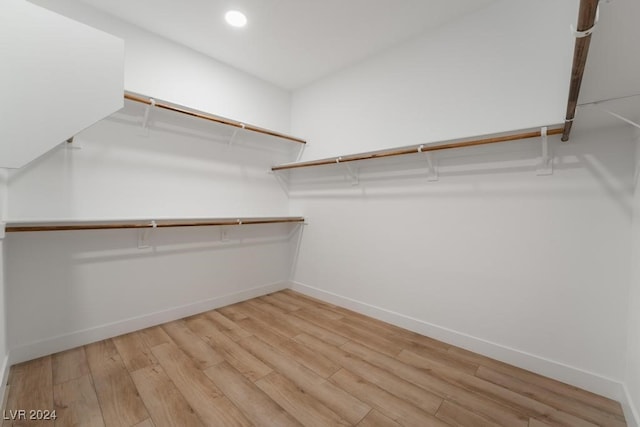 spacious closet featuring light hardwood / wood-style floors