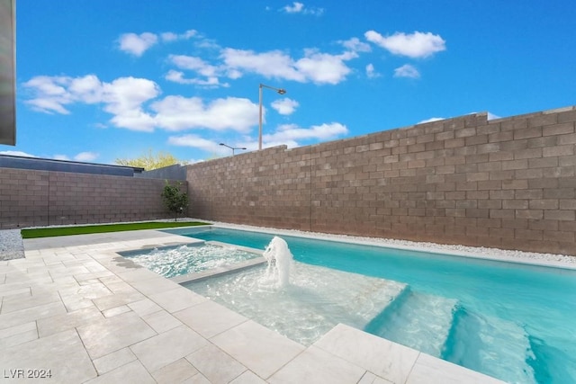 view of swimming pool featuring a patio, a jacuzzi, and pool water feature