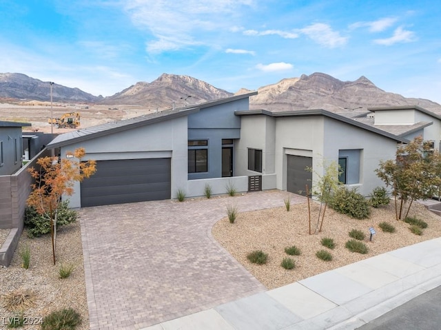 view of front of property with a mountain view and a garage