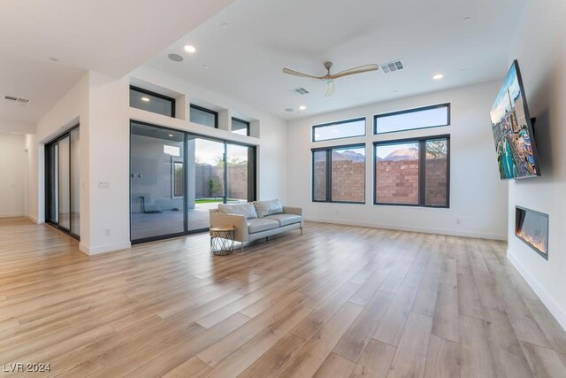 unfurnished living room featuring light hardwood / wood-style floors and ceiling fan