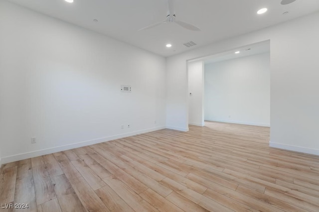 empty room with light hardwood / wood-style floors and ceiling fan