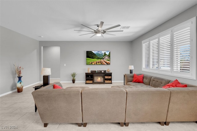 tiled living room featuring plenty of natural light and ceiling fan