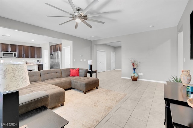 living room featuring ceiling fan and light tile patterned flooring