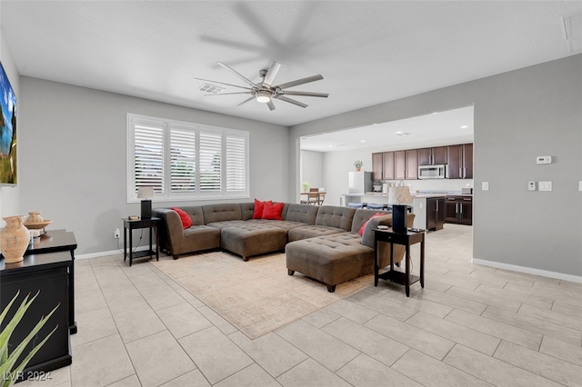 living room with ceiling fan and light tile patterned flooring