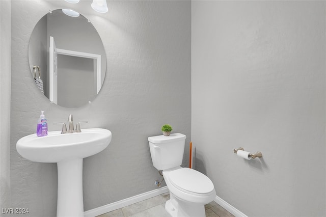 bathroom with tile patterned floors, toilet, and sink