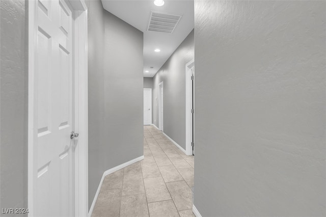 hallway featuring light tile patterned flooring