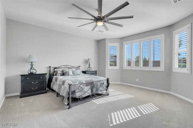 bedroom featuring ceiling fan and light carpet