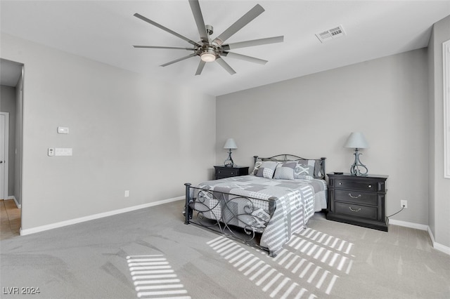 bedroom with light carpet and ceiling fan