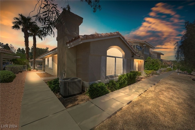 property exterior at dusk with central AC unit