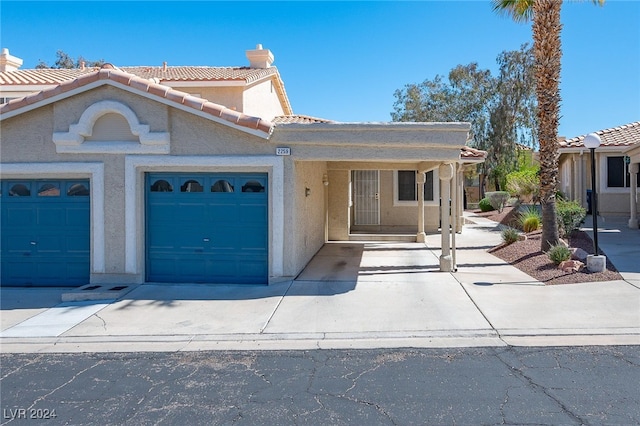 2259 Rugged Mesa Dr, Laughlin, NV 89029 - view of front of property featuring a chimney, driveway, stucco siding, an attached garage, and a tile roof