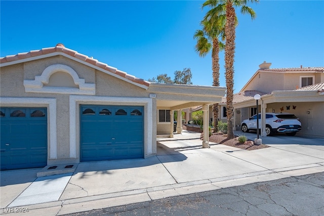 2259 Rugged Mesa Dr, Laughlin, NV 89029 - view of front of house featuring driveway, a garage, stucco siding, and a tiled roof