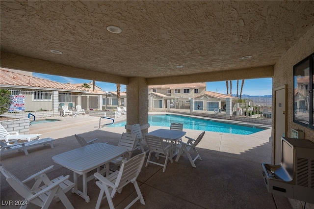 view of swimming pool featuring a patio area