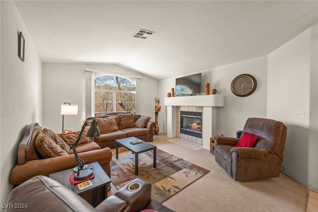 living room featuring light carpet, a fireplace, and vaulted ceiling