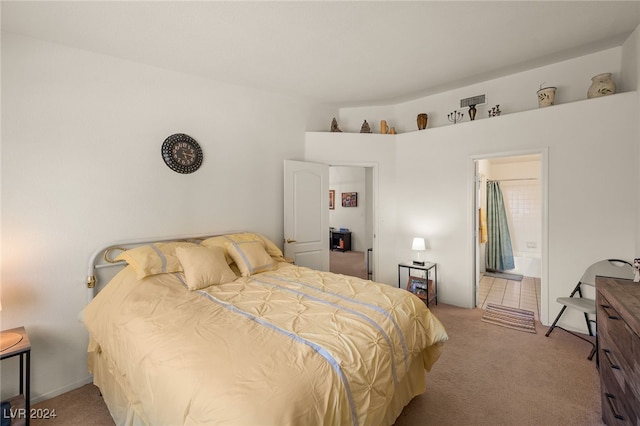 bedroom with light carpet and ensuite bathroom