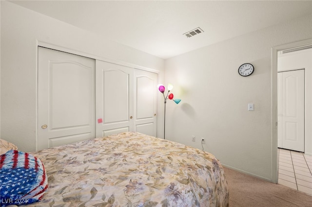 carpeted bedroom featuring a closet