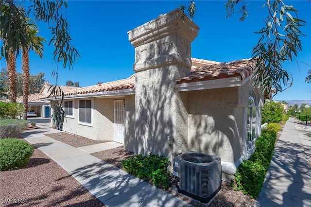 2259 Rugged Mesa Dr, Laughlin, NV 89029 - view of front of home with a tiled roof, stucco siding, and a chimney