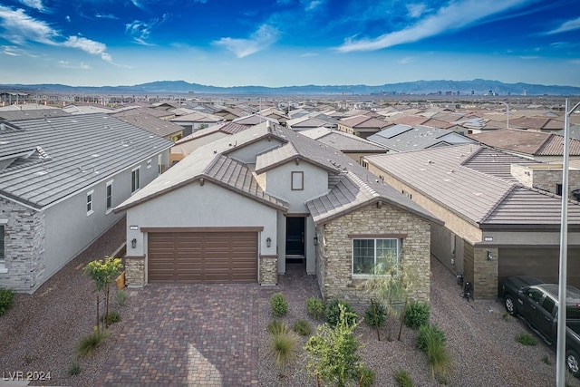 view of front facade featuring a mountain view and a garage