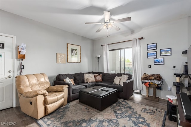 living room with dark hardwood / wood-style floors and ceiling fan