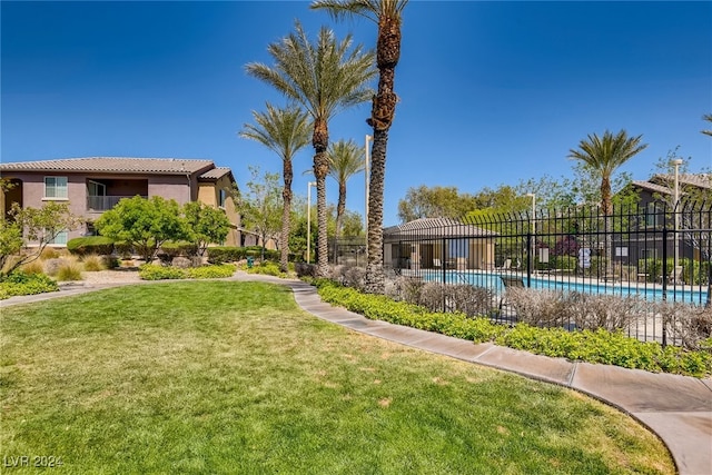 view of yard with a community pool and fence