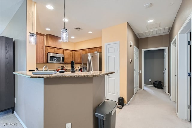 kitchen with light stone counters, stainless steel appliances, visible vents, brown cabinetry, and decorative light fixtures