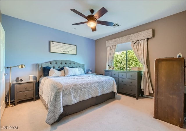 bedroom featuring a ceiling fan, light colored carpet, and visible vents