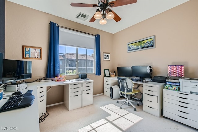 office area featuring baseboards, visible vents, a ceiling fan, and light colored carpet