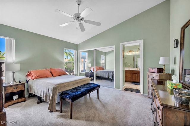 carpeted bedroom featuring high vaulted ceiling, ceiling fan, connected bathroom, and a closet