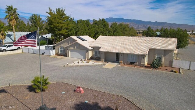 ranch-style home with a mountain view and a garage