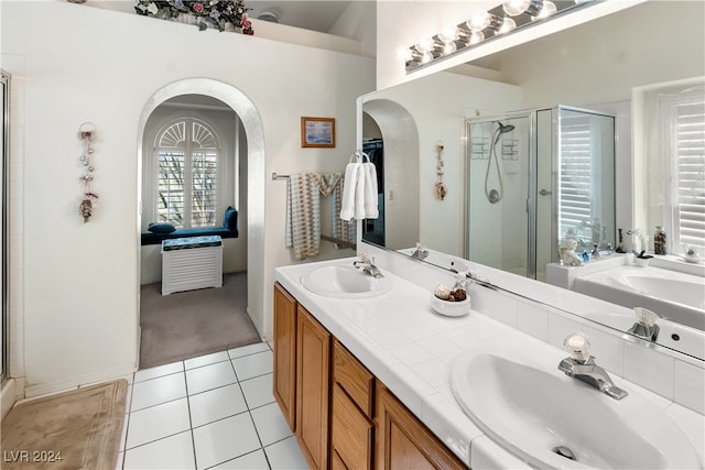 bathroom featuring tile patterned flooring, vanity, and an enclosed shower