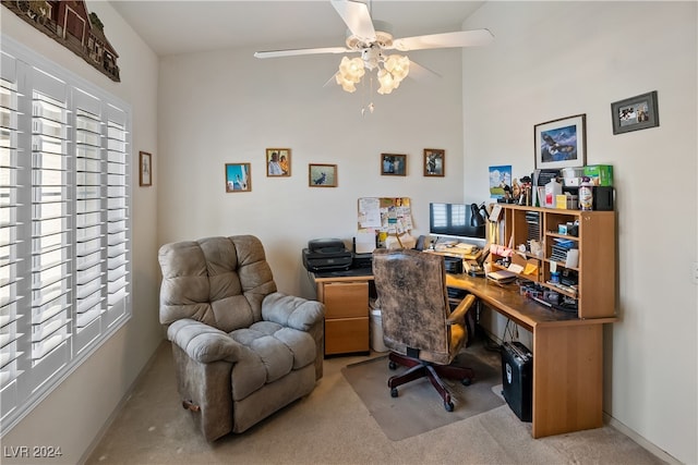 home office with ceiling fan, light colored carpet, and vaulted ceiling