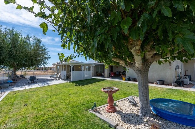 view of yard with a fire pit and a patio area