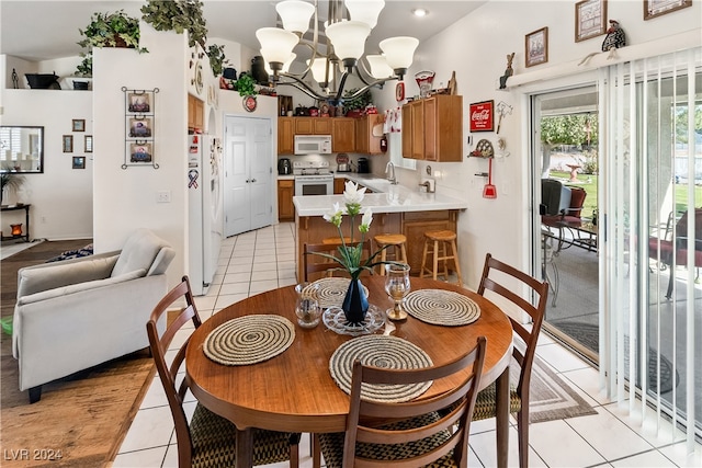 dining area featuring light tile patterned floors, sink, and a chandelier