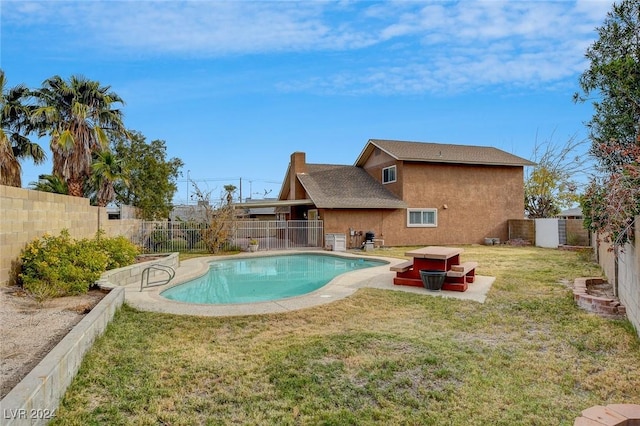 view of pool with a lawn