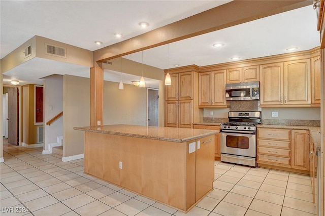 kitchen featuring a center island, hanging light fixtures, light tile patterned floors, light brown cabinetry, and appliances with stainless steel finishes