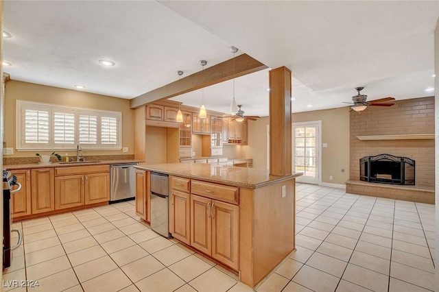 kitchen featuring decorative light fixtures, a fireplace, stainless steel appliances, and a wealth of natural light