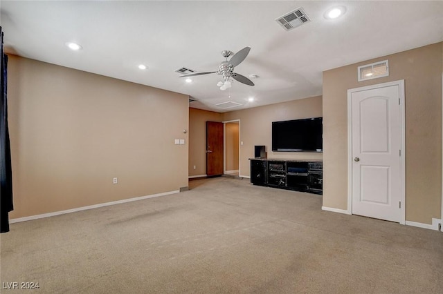 unfurnished living room featuring ceiling fan and light colored carpet