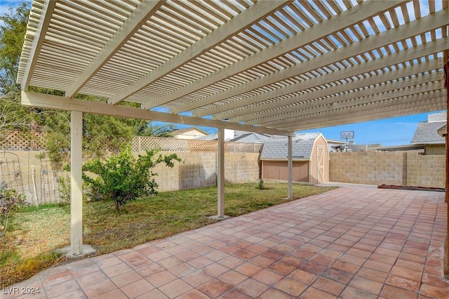 view of patio featuring a pergola and a storage unit