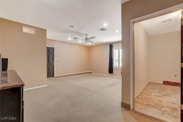 living room featuring ceiling fan and light colored carpet