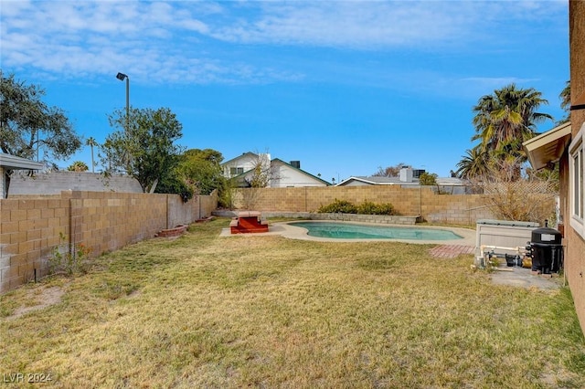 view of yard with a fenced in pool