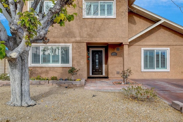 entrance to property featuring a patio