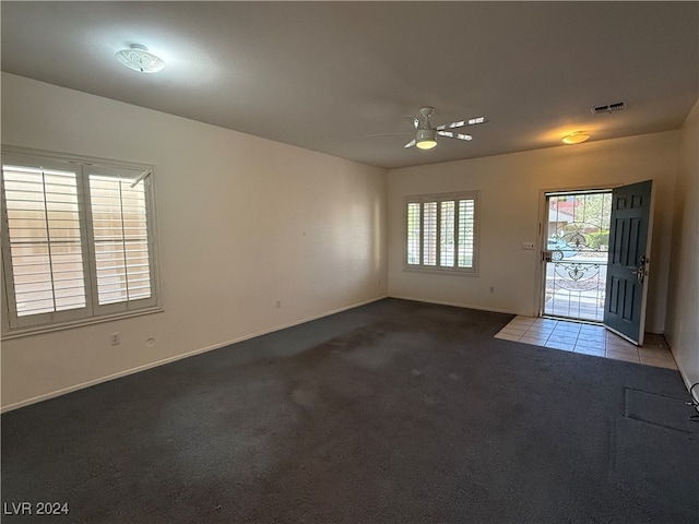 unfurnished room with ceiling fan and light colored carpet