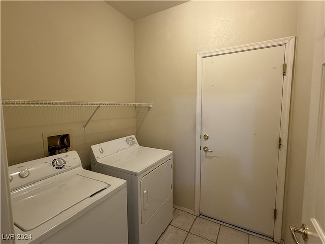 laundry area with light tile patterned flooring and separate washer and dryer