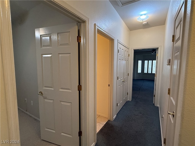 hall featuring light colored carpet