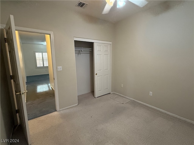 unfurnished bedroom featuring a closet, ceiling fan, and light carpet