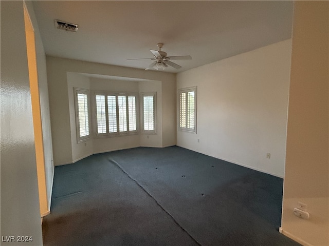 carpeted empty room featuring ceiling fan