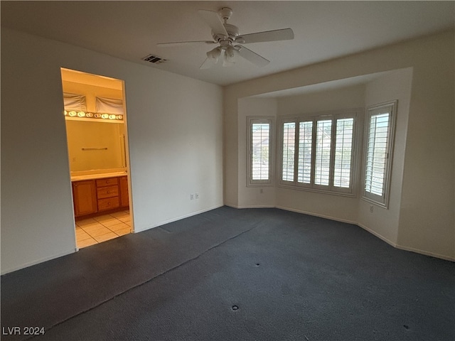 carpeted empty room with ceiling fan