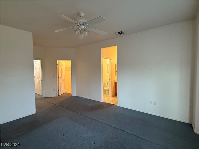 spare room with ceiling fan and light colored carpet