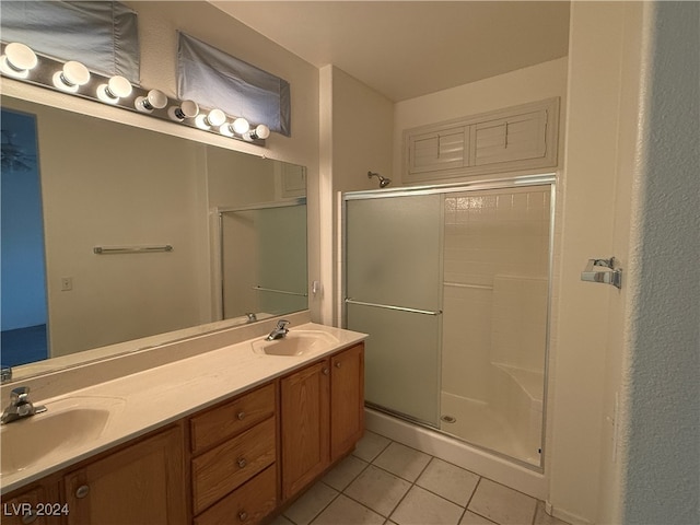 bathroom with vanity, an enclosed shower, and tile patterned flooring