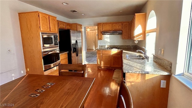 kitchen featuring hardwood / wood-style flooring, sink, and appliances with stainless steel finishes